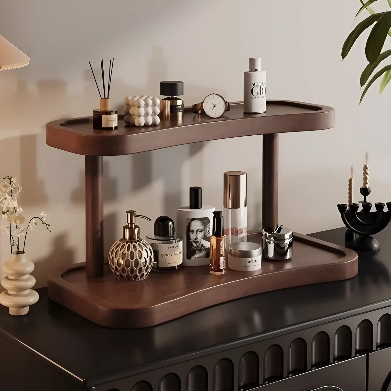 Two-layer bamboo cup storage rack on a tabletop with small items organised on both tiers
