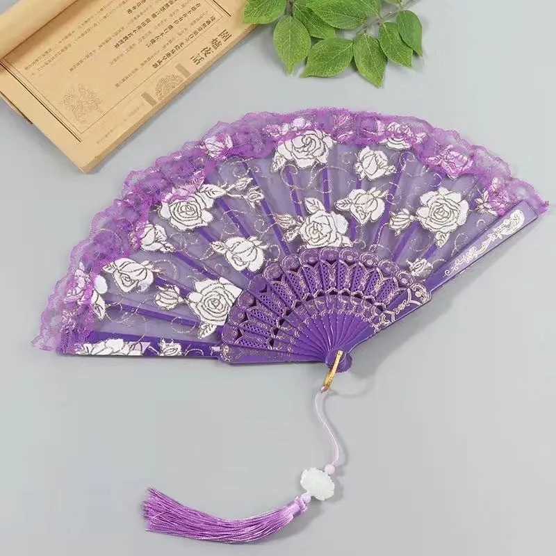 Plastic rose lace folding fan in red with tassel on white background