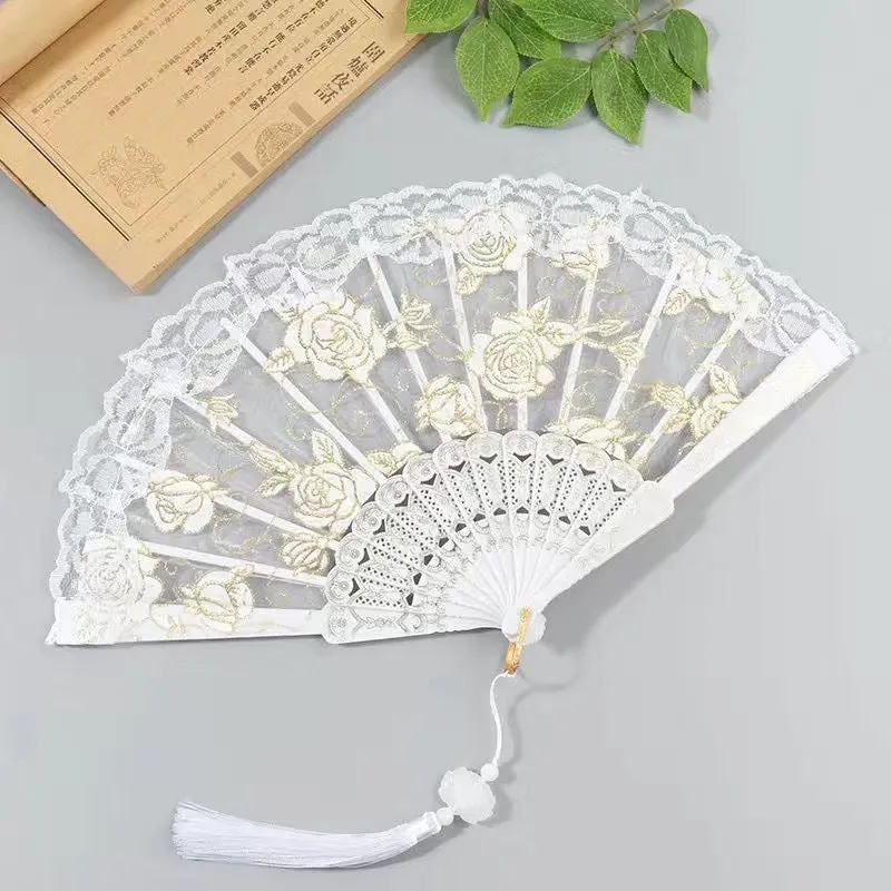 Plastic rose lace folding fan in red with tassel on white background