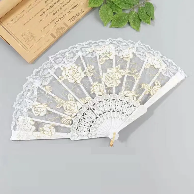 Plastic rose lace folding fan in red with tassel on white background