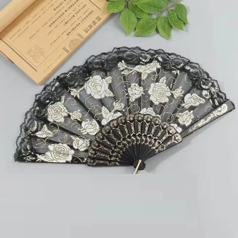 Plastic rose lace folding fan in red with tassel on white background