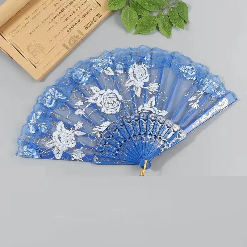 Plastic rose lace folding fan in red with tassel on white background