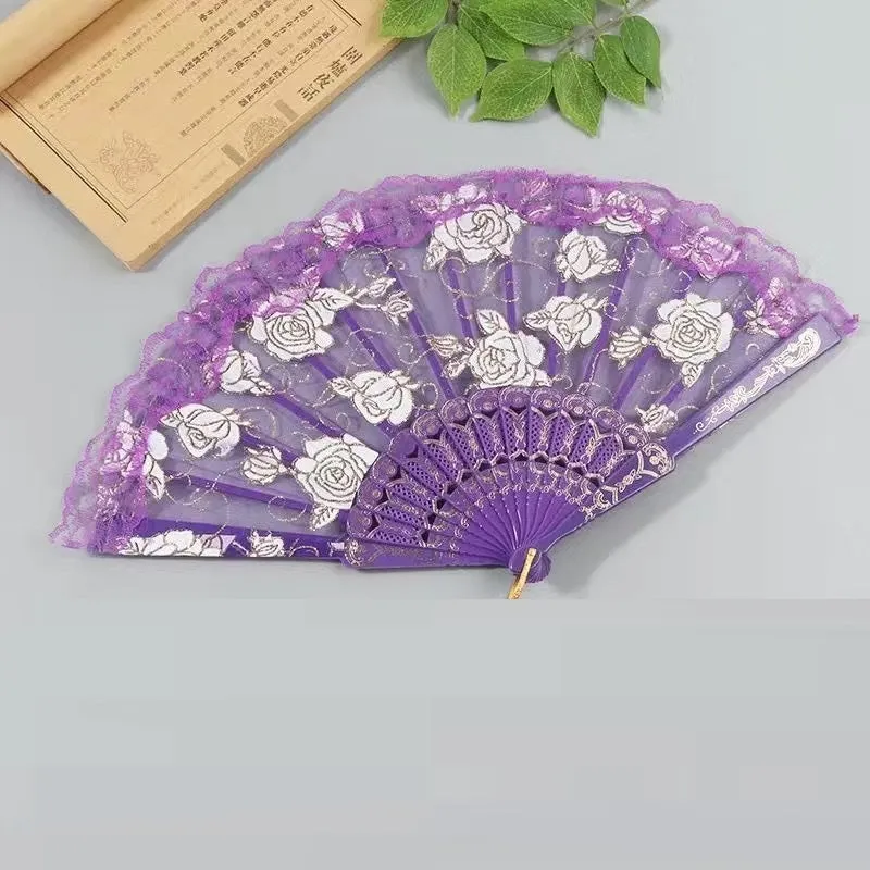 Plastic rose lace folding fan in red with tassel on white background