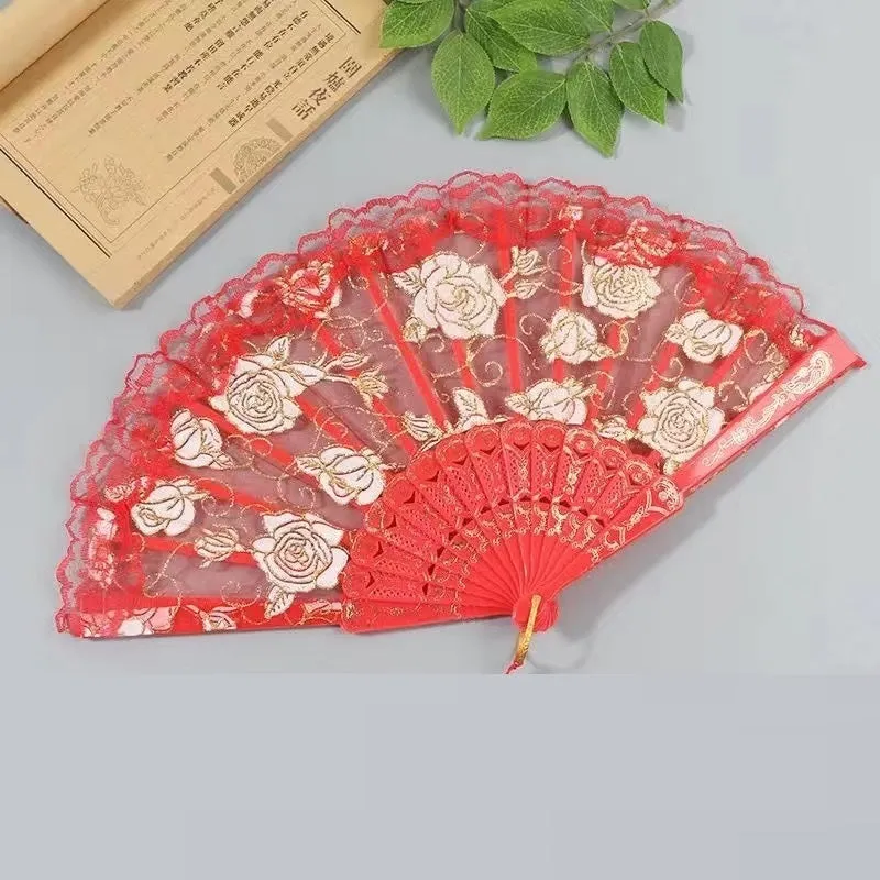 Plastic rose lace folding fan in red with tassel on white background