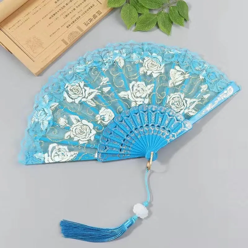 Plastic rose lace folding fan in red with tassel on white background