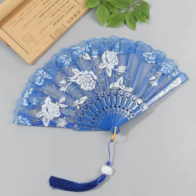 Plastic rose lace folding fan in red with tassel on white background