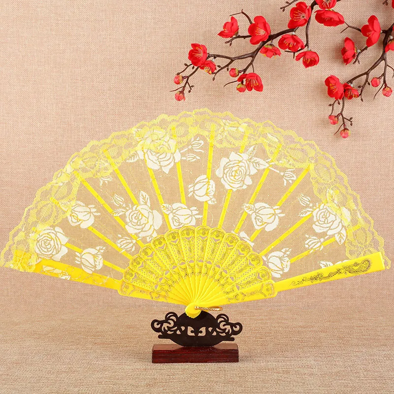 Plastic rose lace folding fan in red with tassel on white background