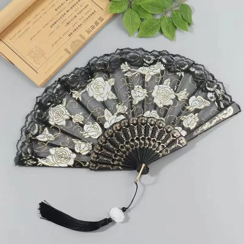 Plastic rose lace folding fan in red with tassel on white background
