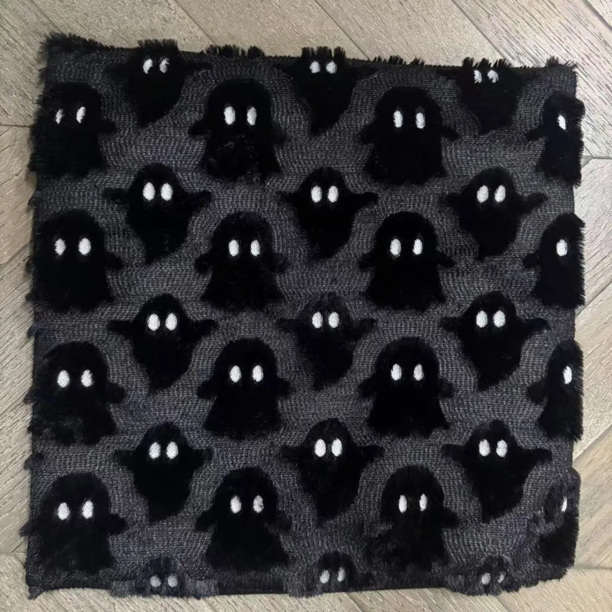 Plush stereo ghost embroidered black and white holiday decorative cushion cover 45x45cm on sofa
