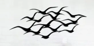 Metal flying bird wall decoration with seagull finish on a white wall