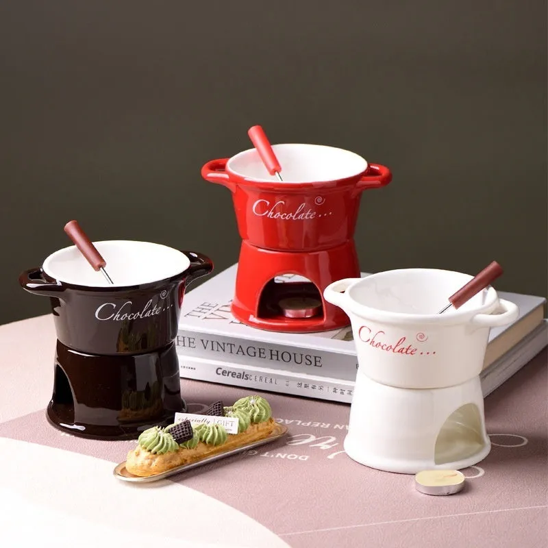 Ceramic binaural hot pot cup in brown for melting chocolate with fork and candle beside it