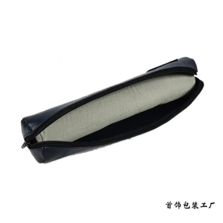 Portable bracelet watch storage bag in black leather with black bracelet stick on a flat surface