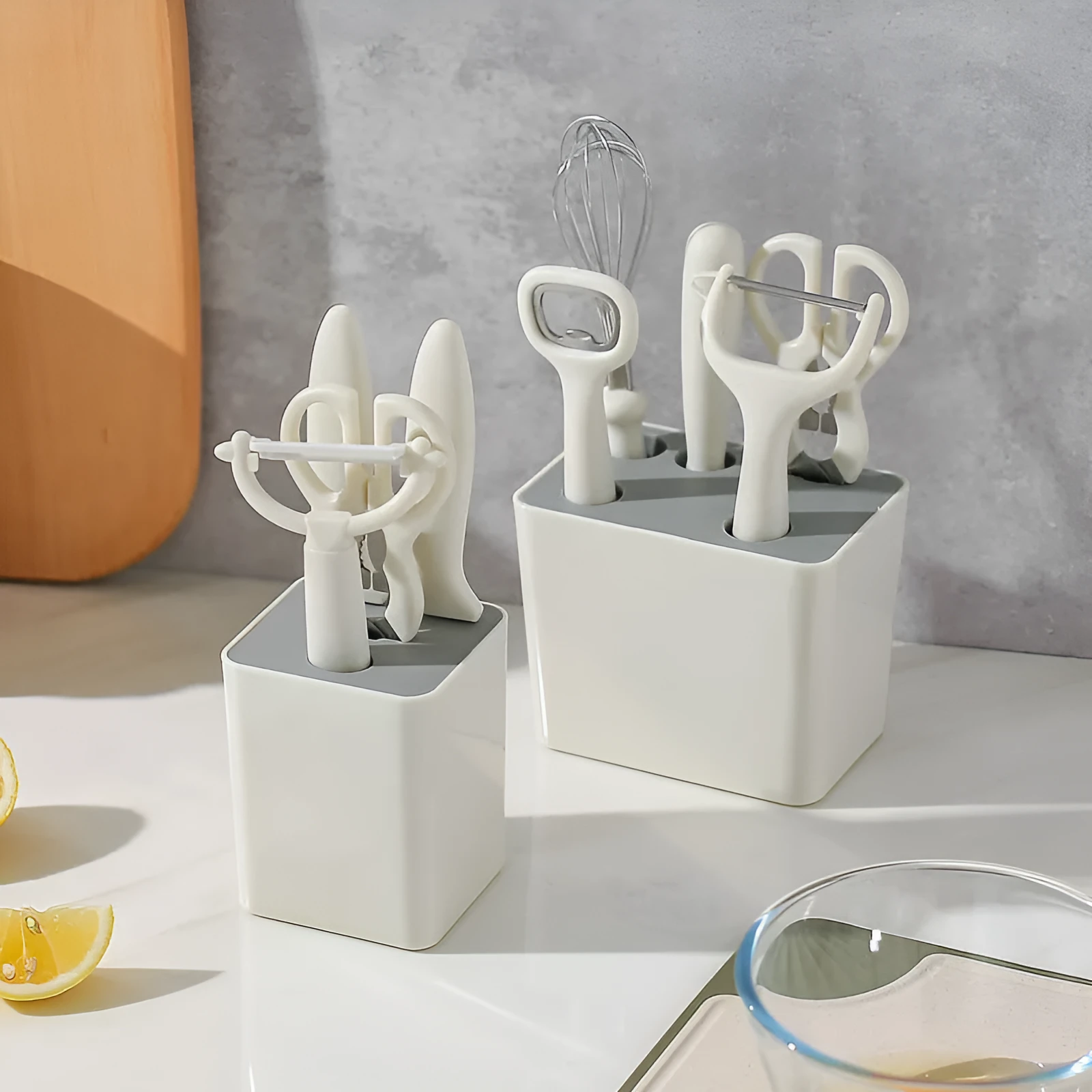 Six-piece white stainless steel kitchen gadget set with modern simplicity design on a clean surface