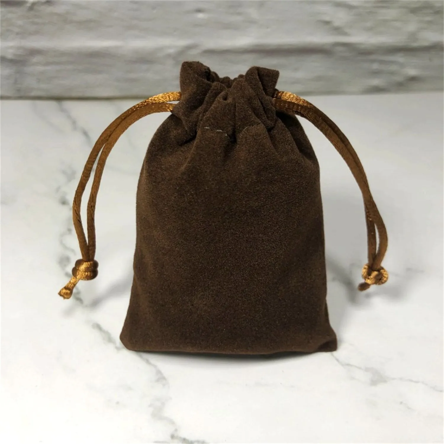 Flannel drawstring bag with beam opening, available in multiple colours and sizes for storage or gifting