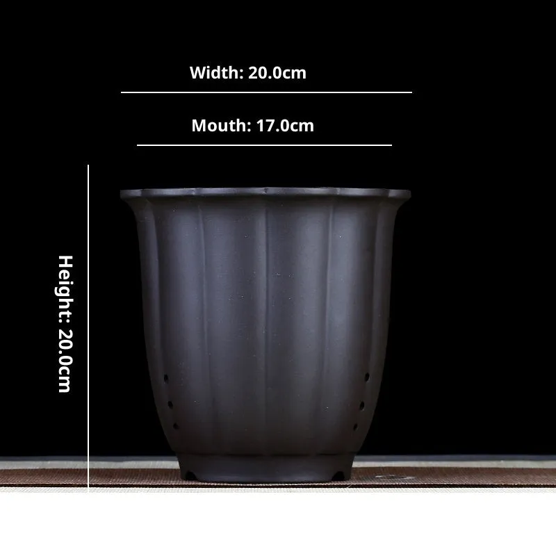 Round ceramic desktop bonsai basin in black with four drainage holes for small plants