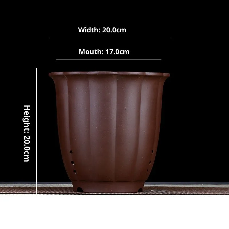 Round ceramic desktop bonsai basin in black with four drainage holes for small plants