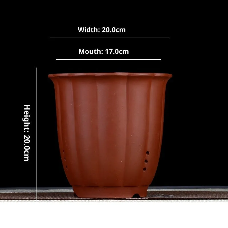 Round ceramic desktop bonsai basin in black with four drainage holes for small plants
