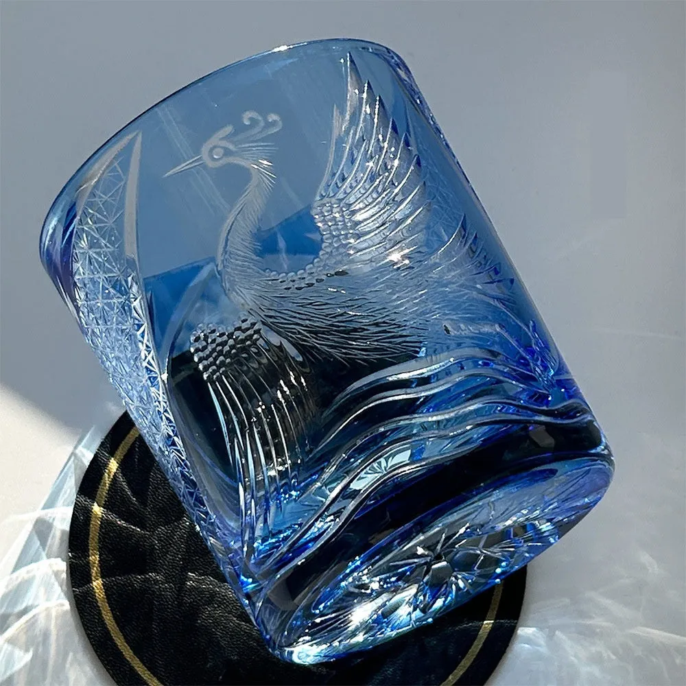 Hand carved crystal whiskey shot glass in sky blue with crane motif, 90x100mm