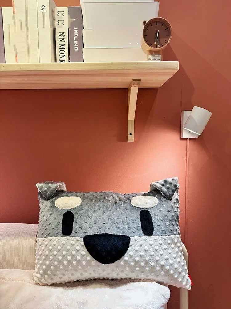 Grey and white West Highland puppy pillow dog cushion on a sofa.