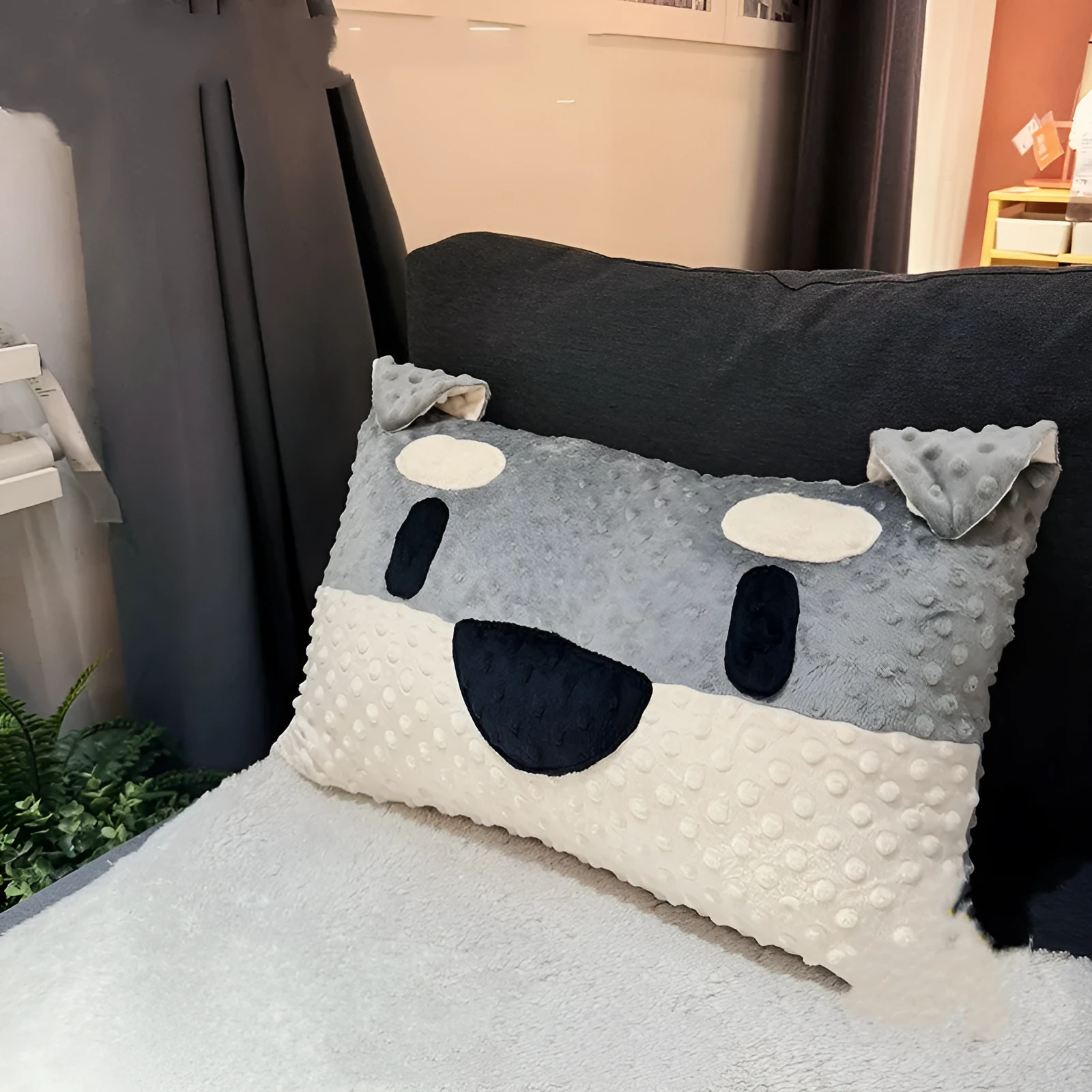 Grey and white West Highland puppy pillow dog cushion on a sofa.