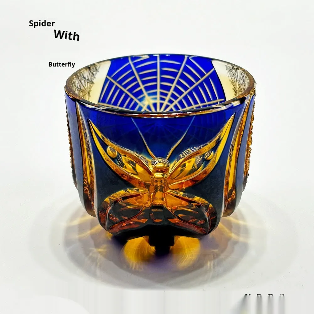 Handmade crystal glass spider wine glass with blue cobweb pattern on a table