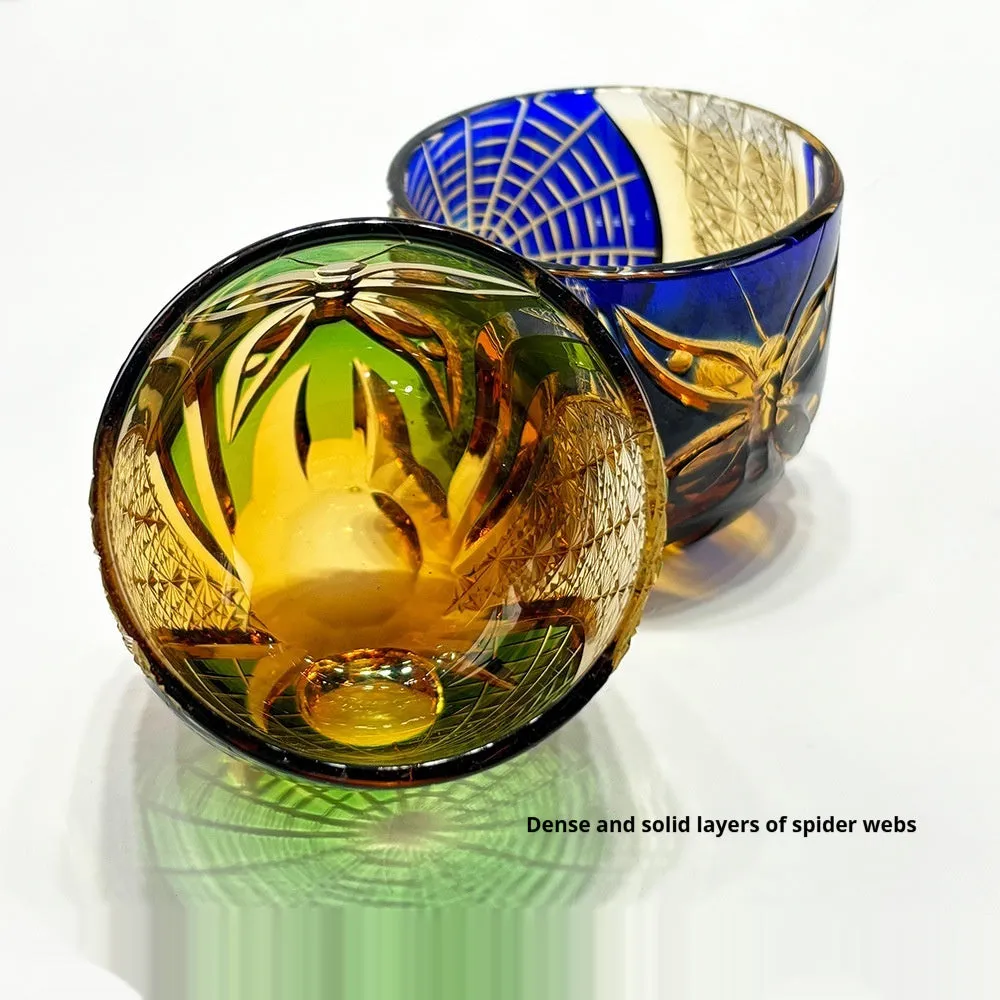 Handmade crystal glass spider wine glass with blue cobweb pattern on a table