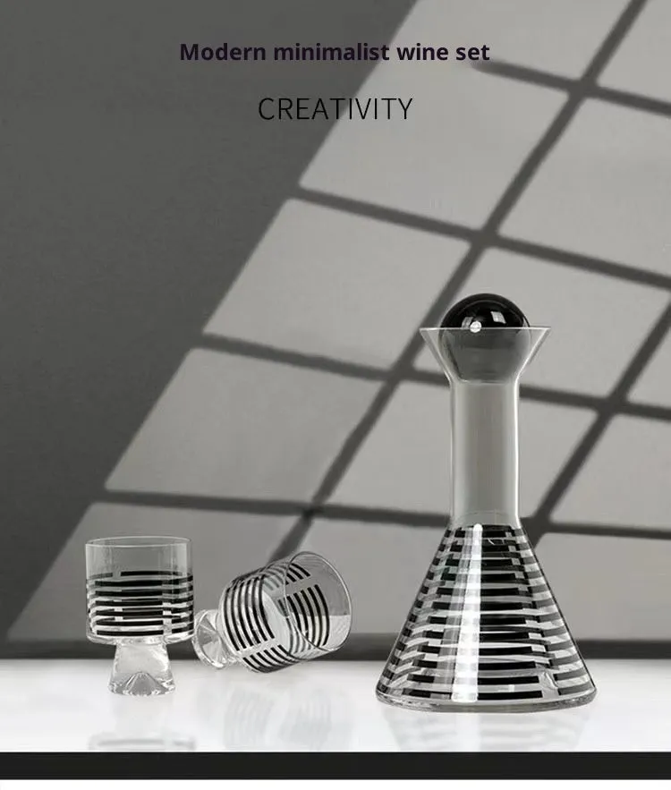 Modern black striped glass cold water bottle 1000ml with two cups on a light surface