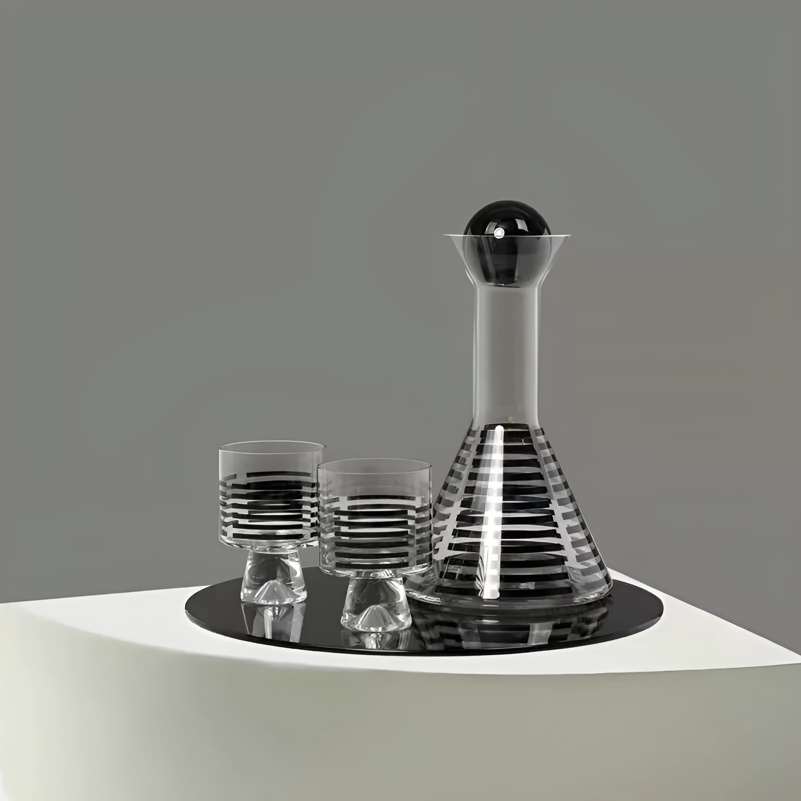 Modern black striped glass cold water bottle 1000ml with two cups on a light surface