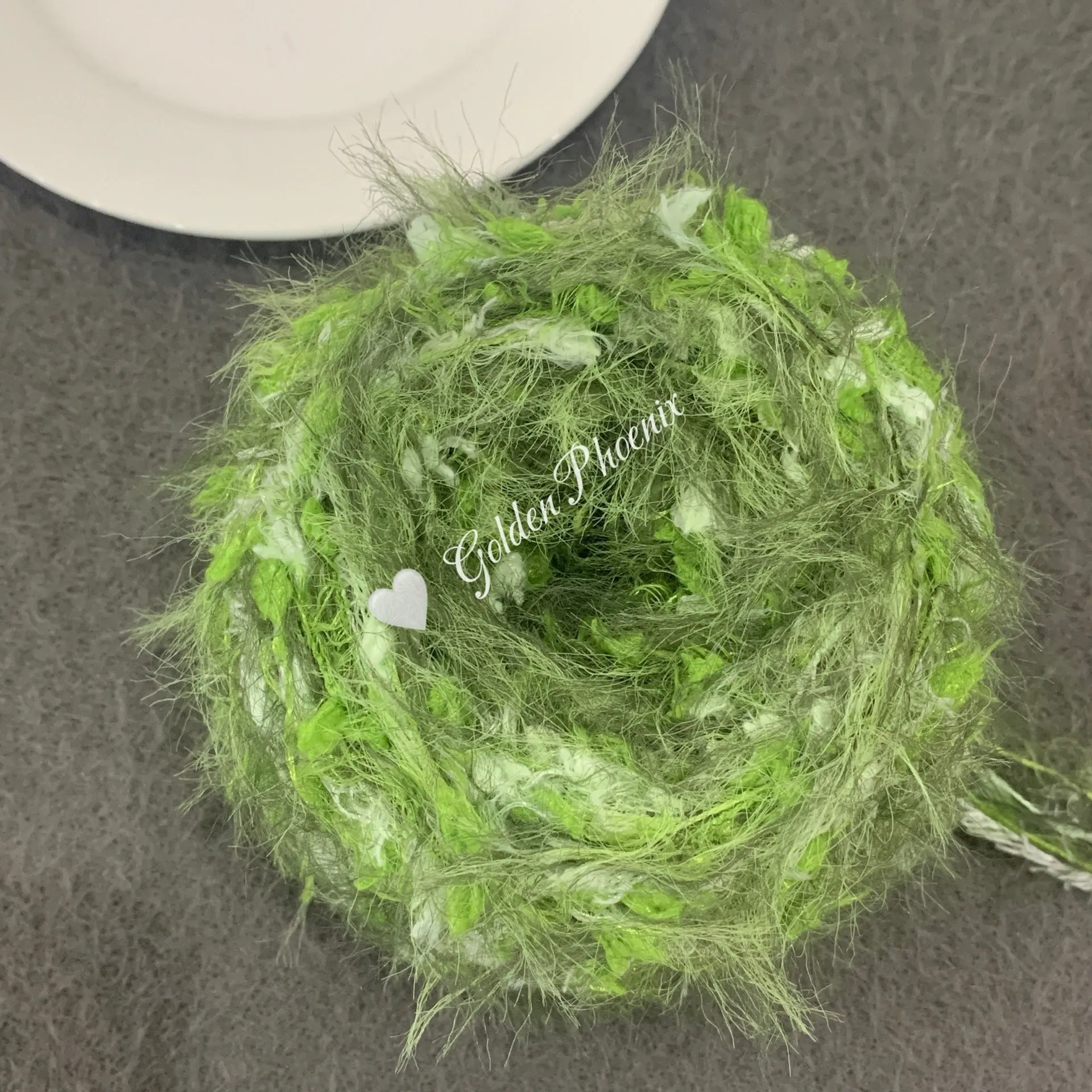 Hand-woven soft polyester yarn in green with 6mm crochet effect texture on skein