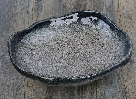 Creative ceramic Japanese-style irregular shaped bowl with floral decoration and sauce dish