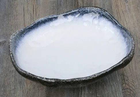 Creative ceramic Japanese-style irregular shaped bowl with floral decoration and sauce dish