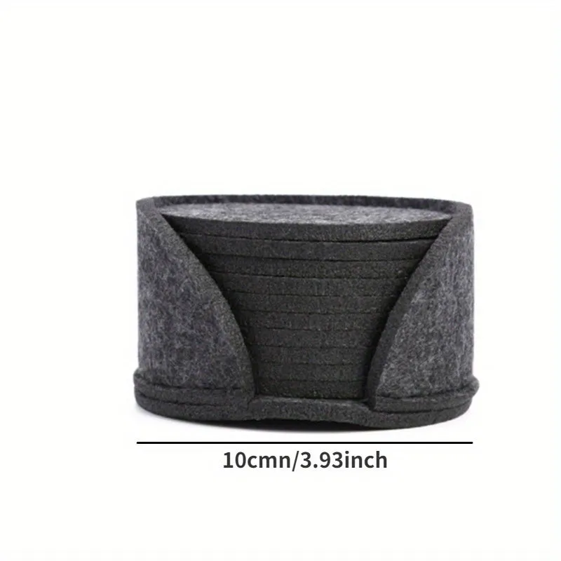 10 round felt coasters in black, brown, dark gray, and light gray arranged on a dining table