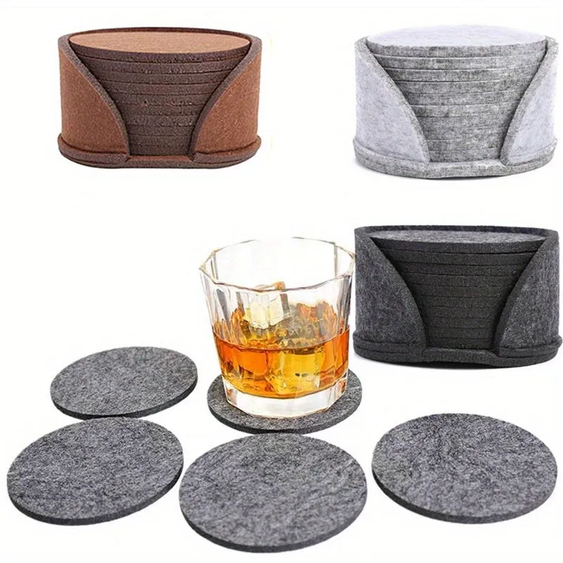 10 round felt coasters in black, brown, dark gray, and light gray arranged on a dining table