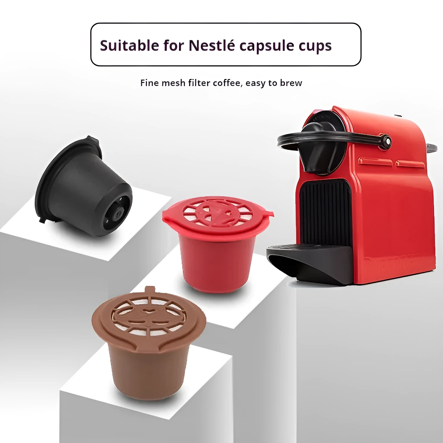 Six reusable black plastic coffee capsule filter cups with a spoon on a table