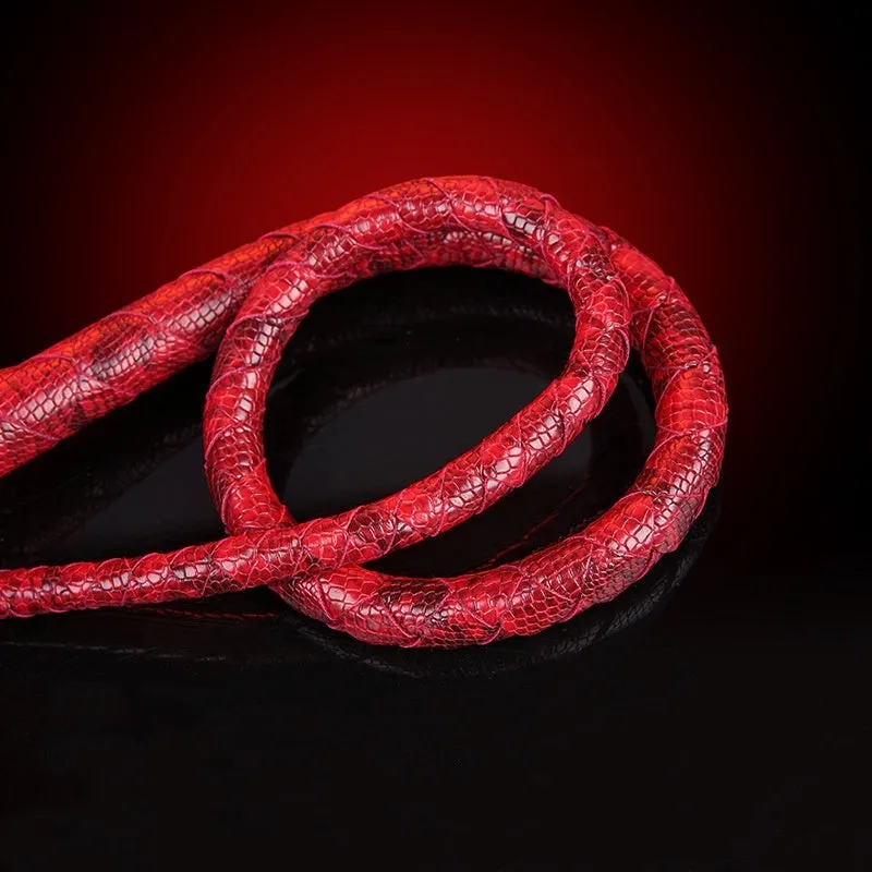 Red PU willow leaf whip BDSM training tool on black background