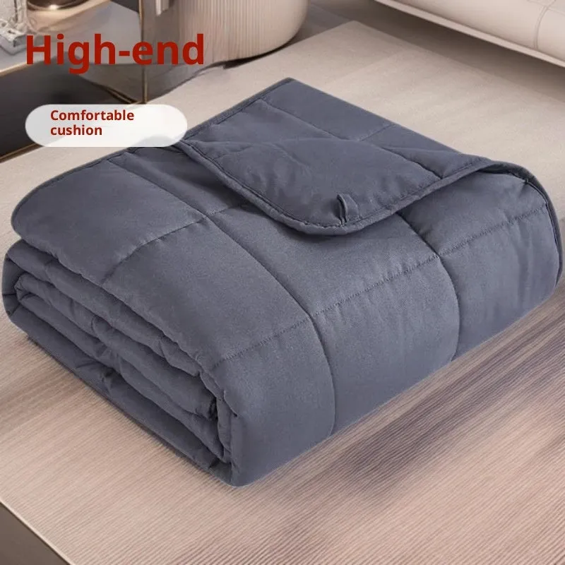 Polyester gravity blanket in solid light grey on bed, 152x203cm size, 12 lb weight option
