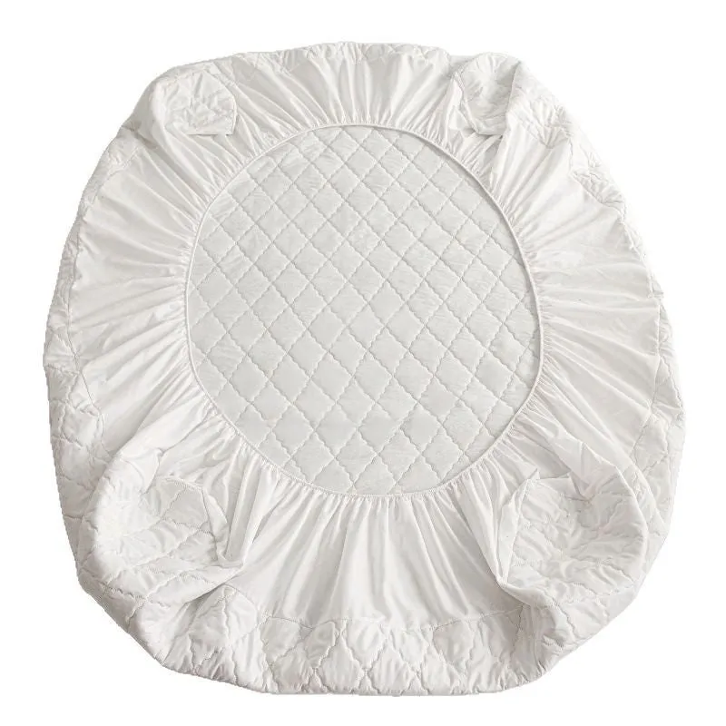 Diamond quilted black waterproof mattress protector fitted sheet and pillowcases set on a bed