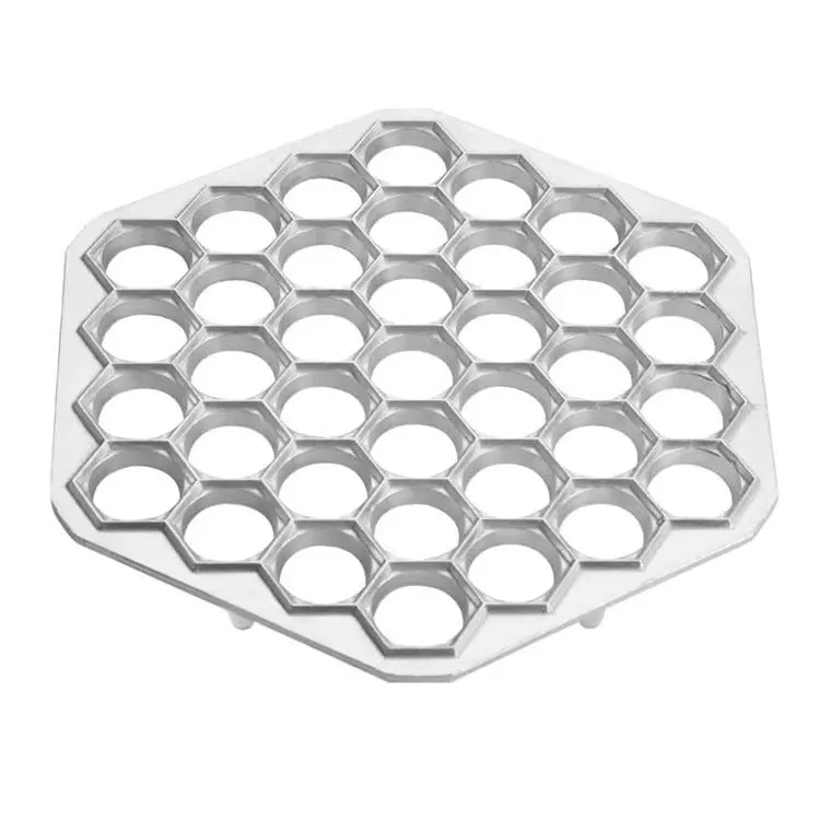 Creative dumpling mold with 37 holes made from aluminium alloy on a kitchen counter