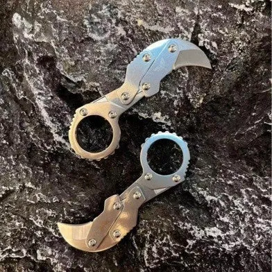 Small stainless steel 420J2 folding knife with 2.6cm blade on table