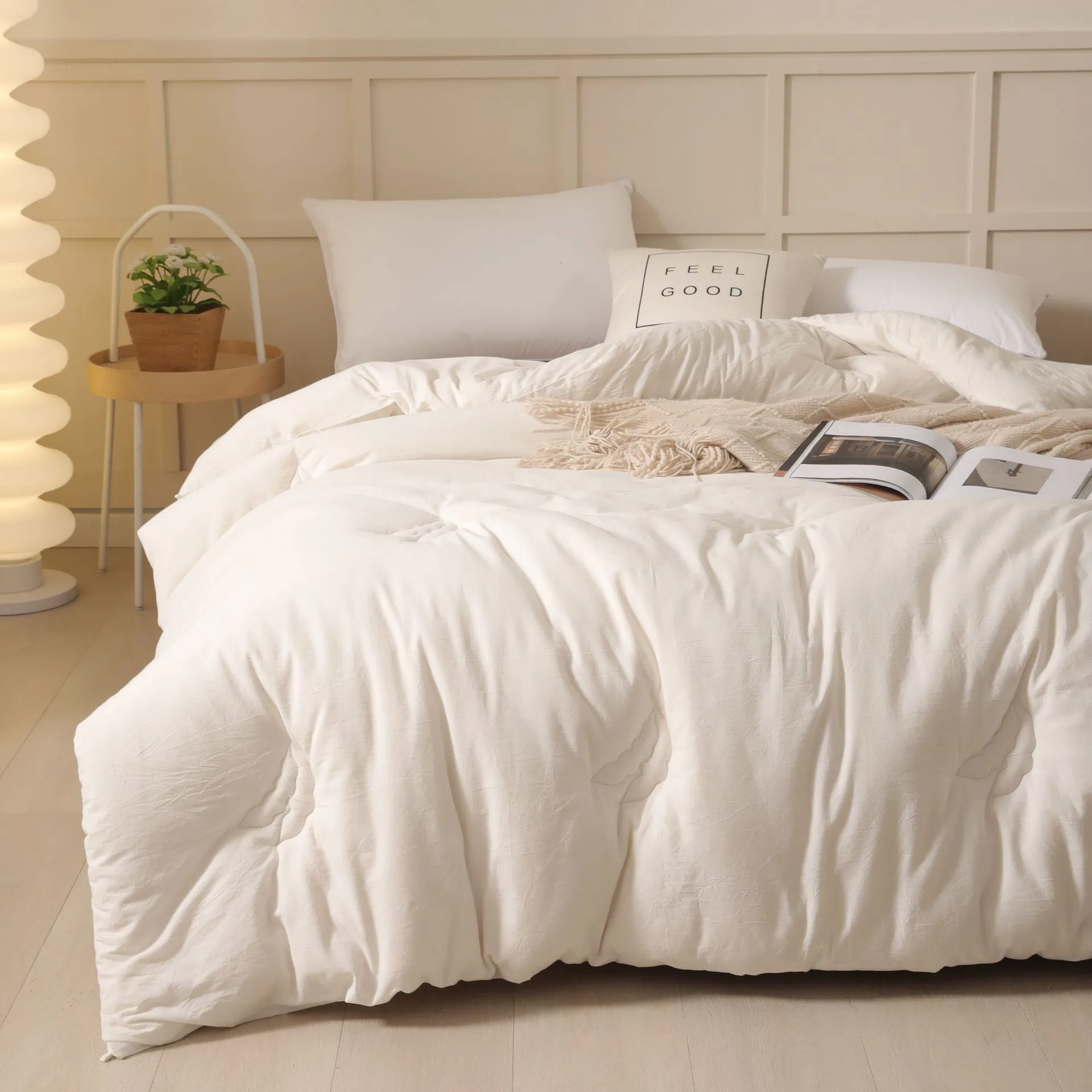 A pure cotton soybean fibre quilt in grey, shown folded, with details of its twill weave and size label.