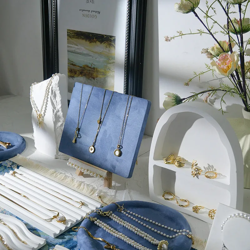 Handmade plaster jewellery display tray with necklaces and bracelets on a countertop