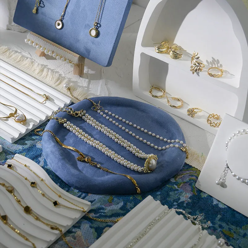 Handmade plaster jewellery display tray with necklaces and bracelets on a countertop