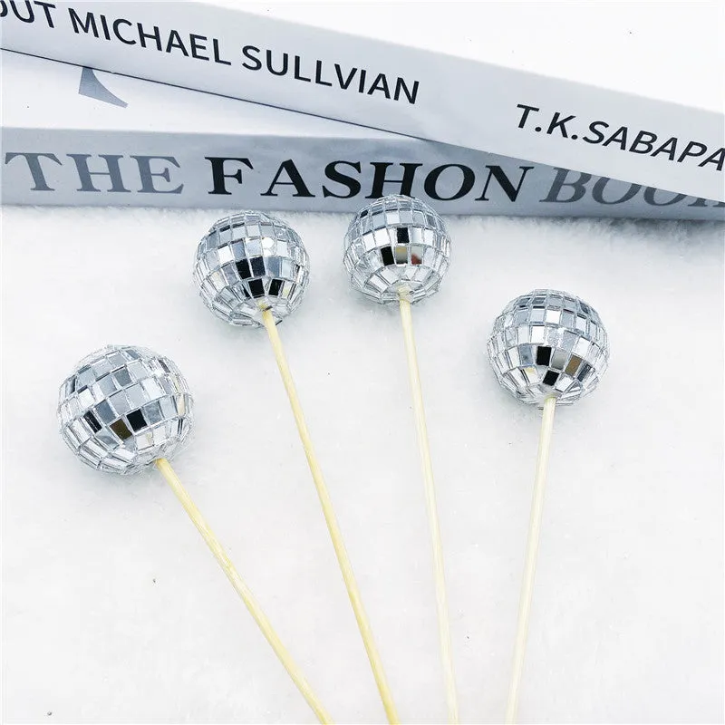 Glass mirrored disco ball cake decoration on a wooden stick, shown in different sizes.