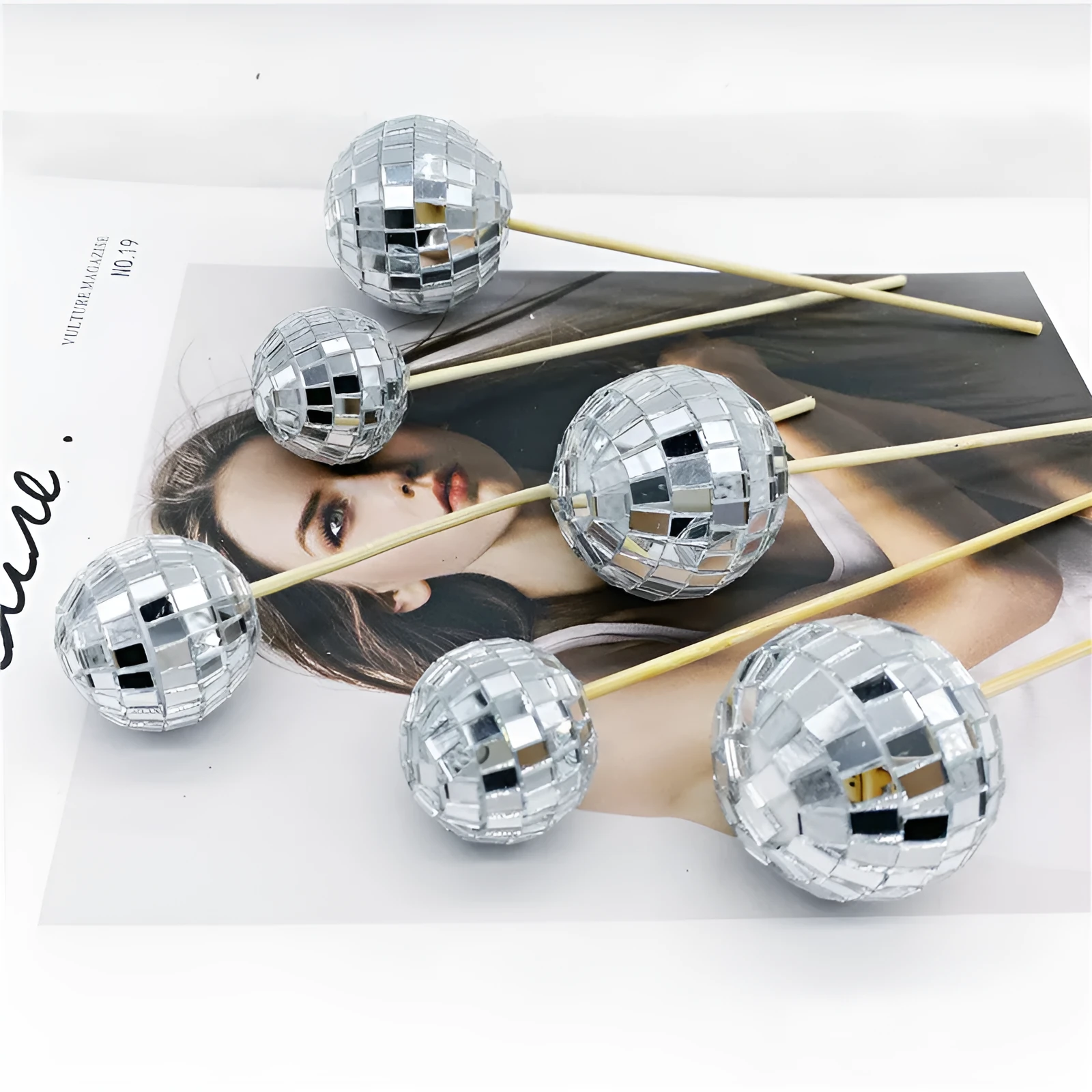 Glass mirrored disco ball cake decoration on a wooden stick, shown in different sizes.
