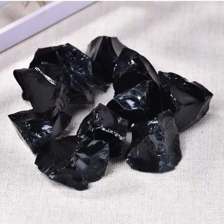 Natural black obsidian rough gravel stones in a pile, size 2-3cm each