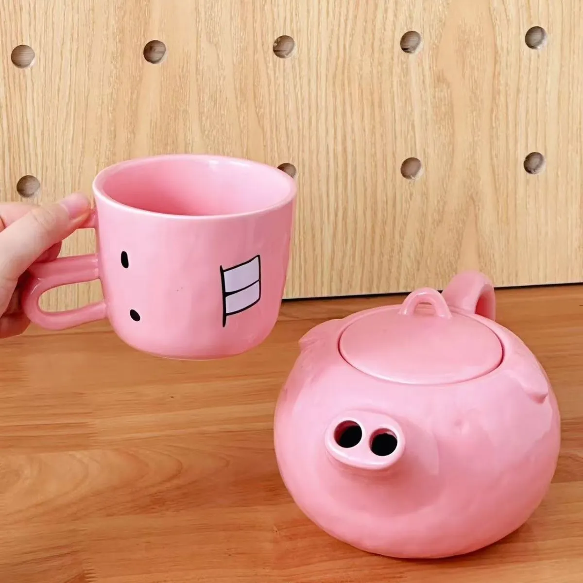 Creative ceramic piggy teapot nose mug set with pink pig pot and rabbit cup on a table