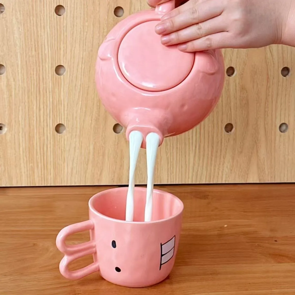 Creative ceramic piggy teapot nose mug set with pink pig pot and rabbit cup on a table