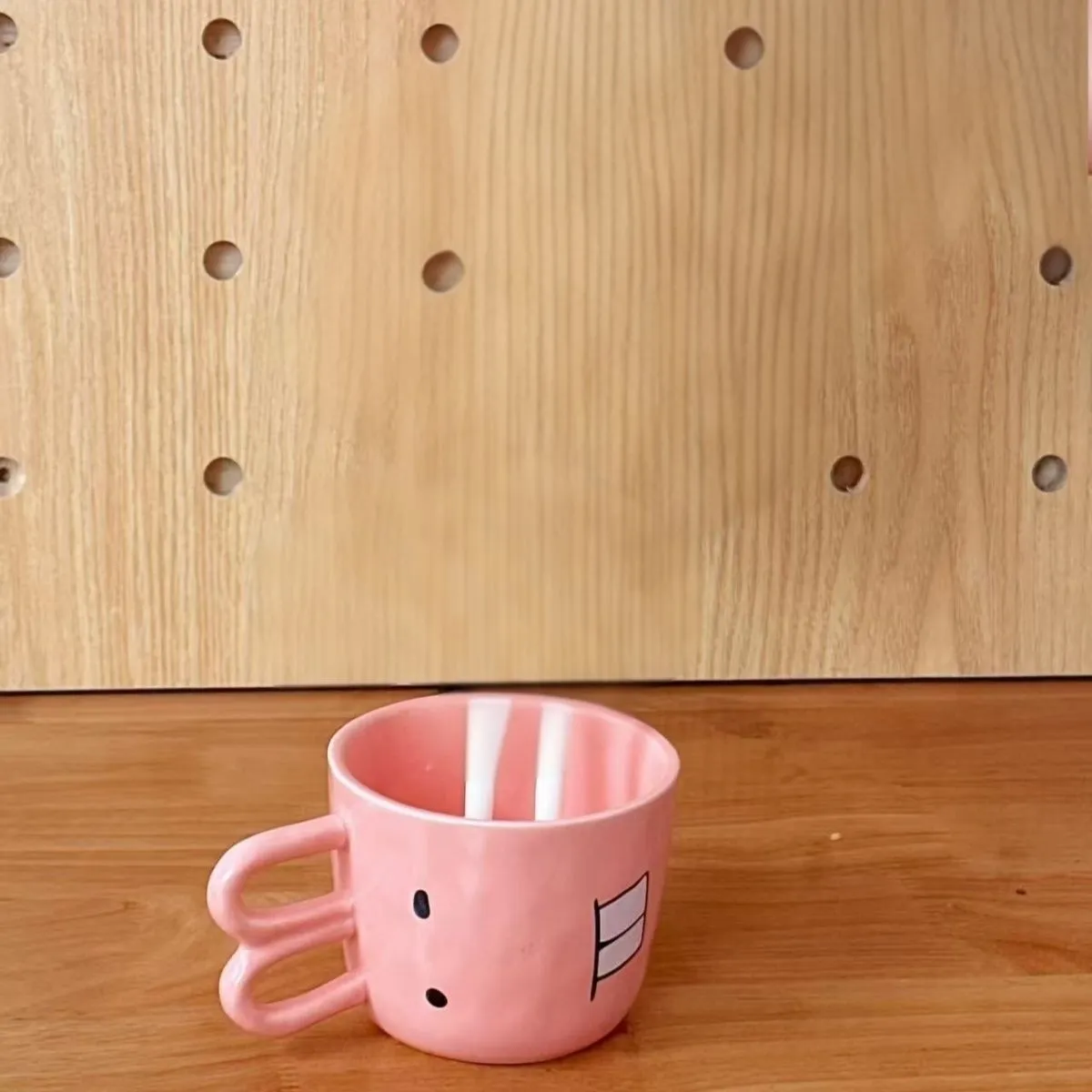 Creative ceramic piggy teapot nose mug set with pink pig pot and rabbit cup on a table