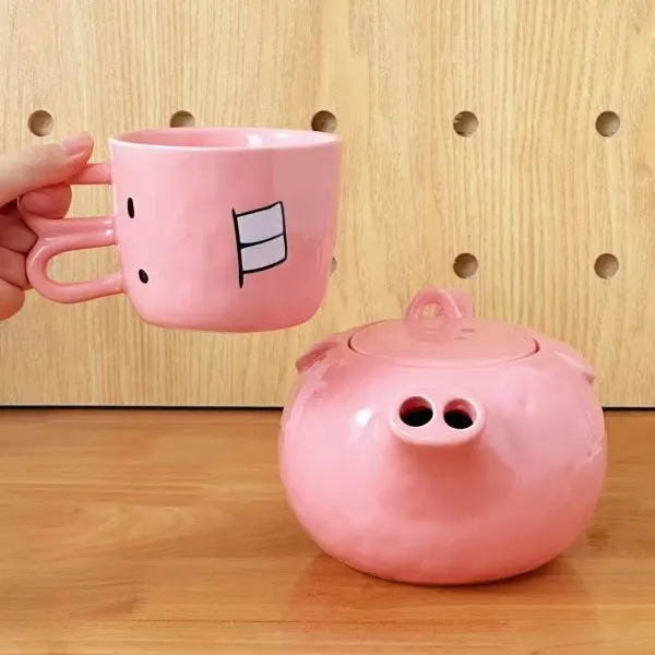 Creative ceramic piggy teapot nose mug set with pink pig pot and rabbit cup on a table