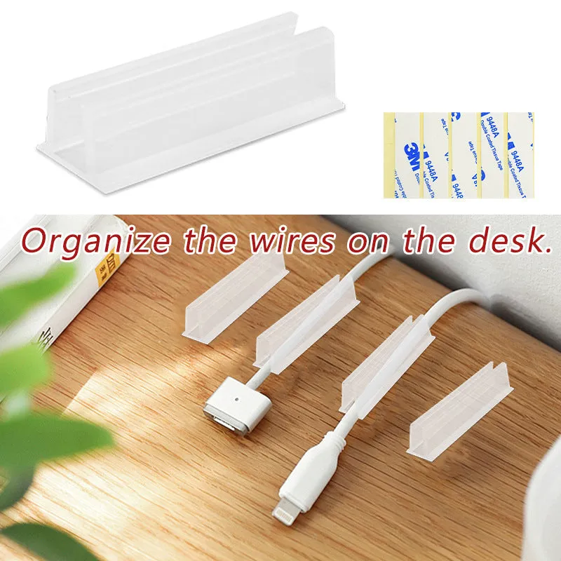 Set of sticky plastic wall-mounted brackets holding data cables on a white wall in a bedroom
